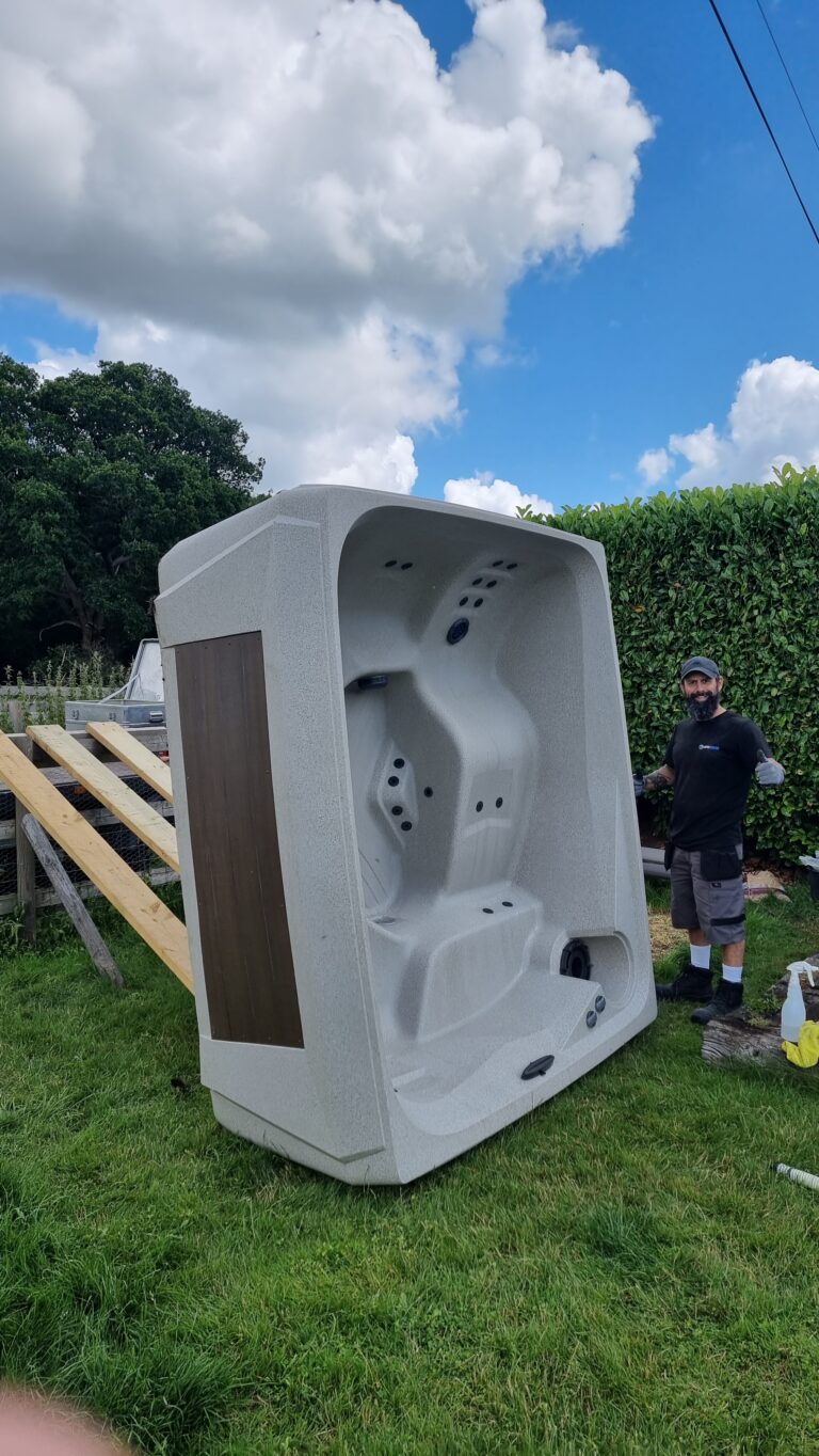 Professional hot tub relocation service showing a spa being safely moved on its side using specialist equipment.