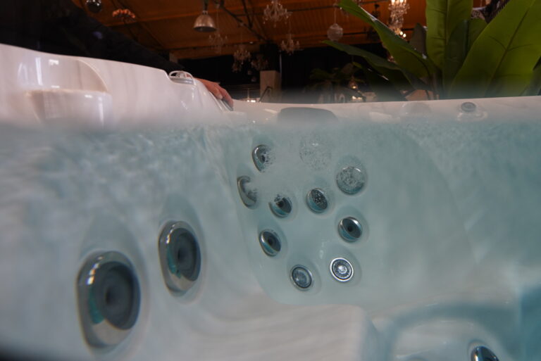 Underwater seating position in a Jacuzzi® J-14 Pro Swim Spa showing some jets running with bubbles and others switched off
