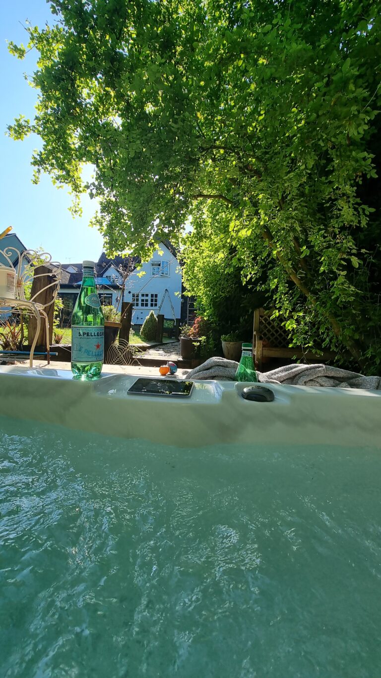 San Pellegrino sparkling water on the edge of a hot tub in Stansted Mountfitchet